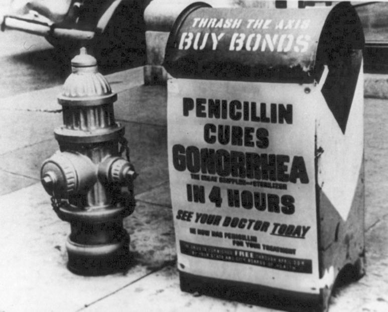 A poster attached to a curbside mailbox offering advice to World War II servicemen: Penicillin cures gonorrhea in 4 hours.