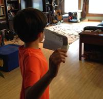 Boy preparing to test a paper airplane.